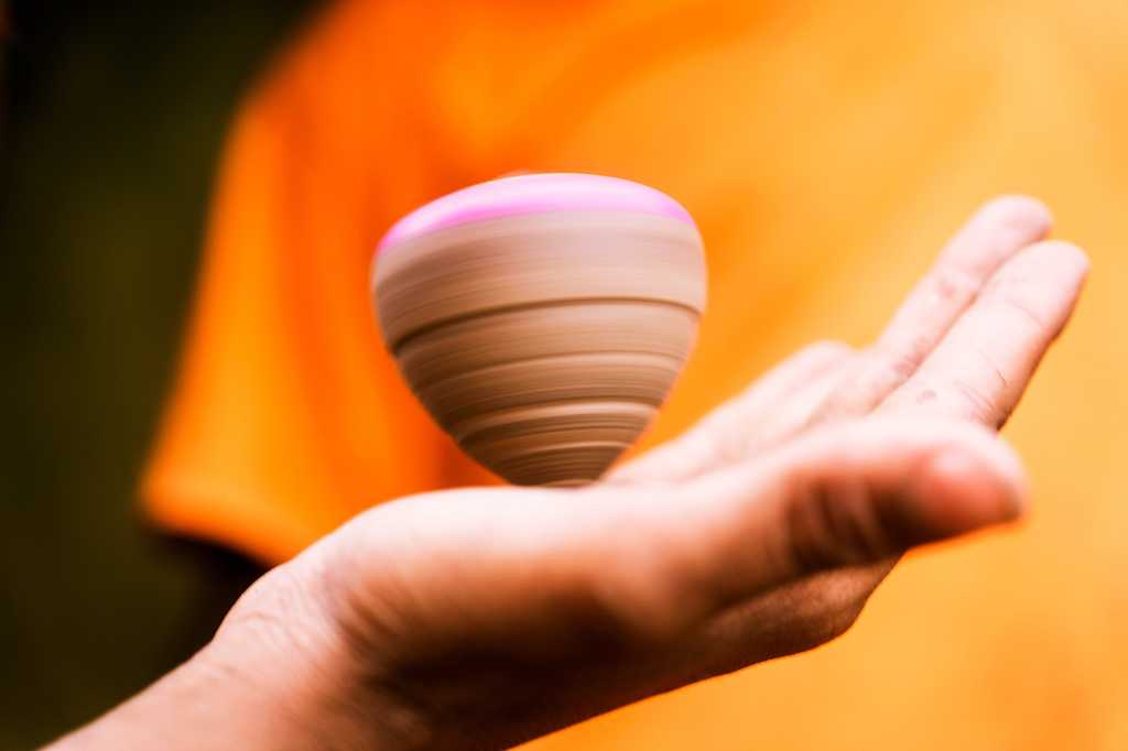 Spinning top in someone's hand.