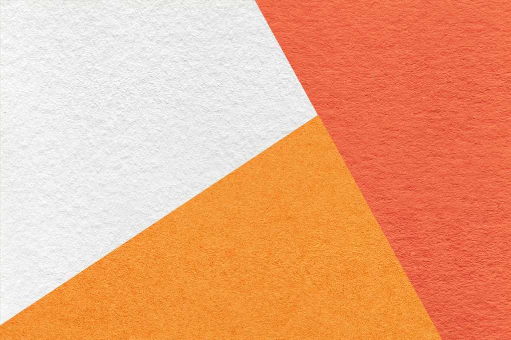 Abstract cardboard design with geometric shapes in orange, light orange, and white.